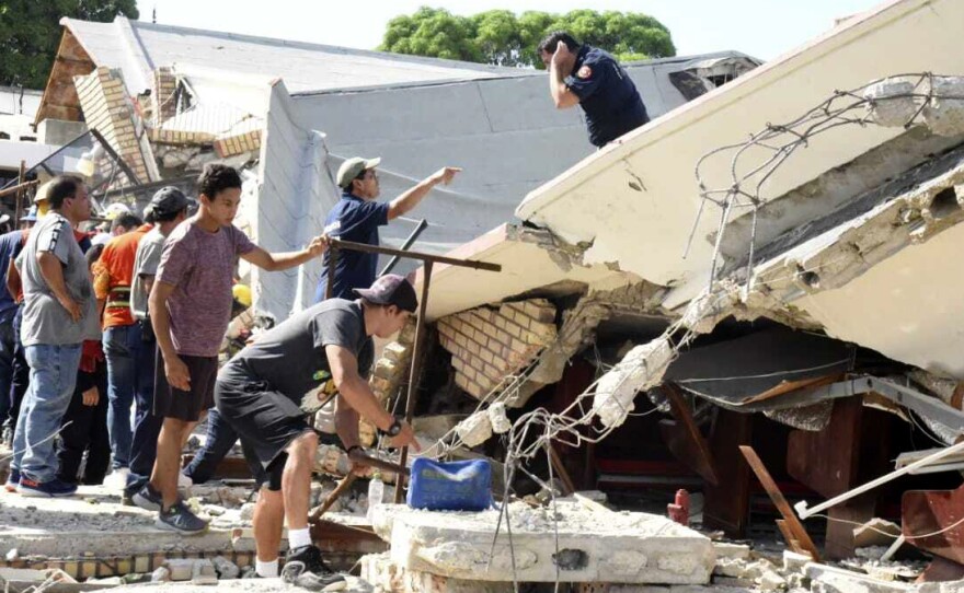 Rescue workers search for survivors amid debris after the roof of a church collapsed during a Sunday Mass in Ciudad Madero, Mexico, on Sunday.