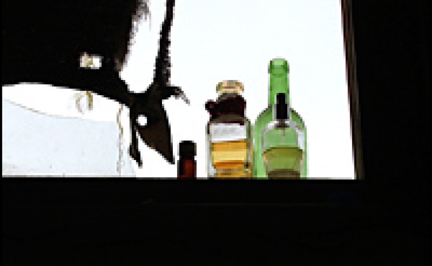 Bottles of experimental fragrances sit in a broken window at the distillery of Azizi and entrepreneur Abdullah Arsallah in Jalalabad.