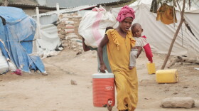 A displaced person walks through a camp in Taiz province, Yemen, Tuesday, Sept. 15, 2026.