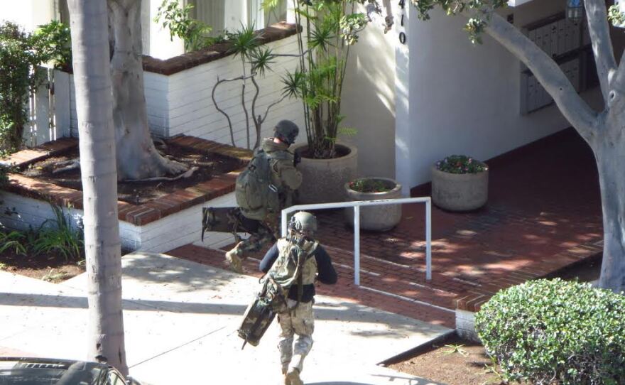 Two members of the San Diego police SWAT team respond to an incident at an apartment complex in Bankers Hill, Nov. 4, 2015.
