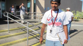 A canvassers with Mi Familia Vota looks for voters to register in front of the DMV in Las Vegas.