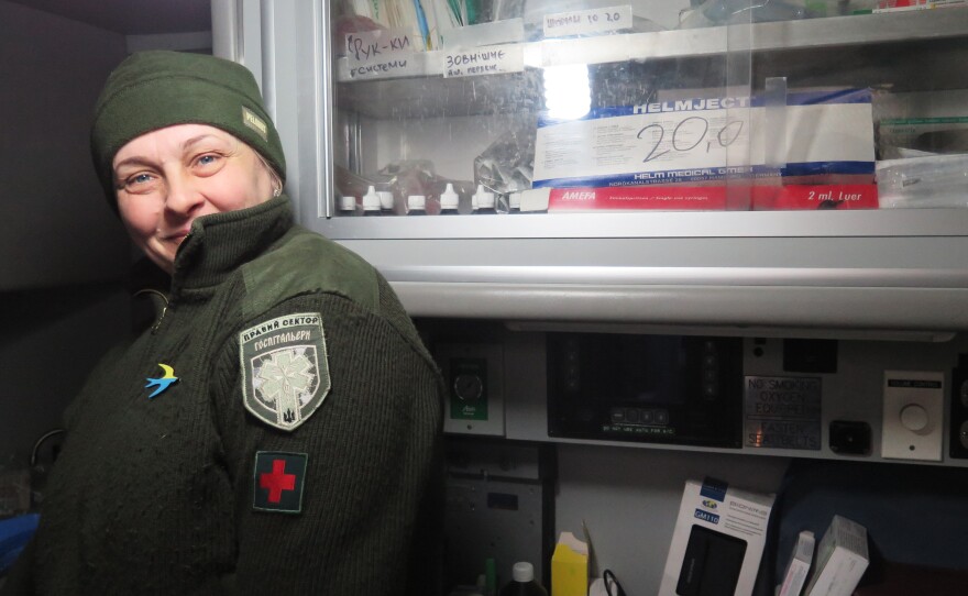 "Mama," like many members of the Right Sector militia in Ukraine's Pisky village, goes only by her nickname.  She stands inside the donated American ambulance that serves as a medical station for wounded troops.