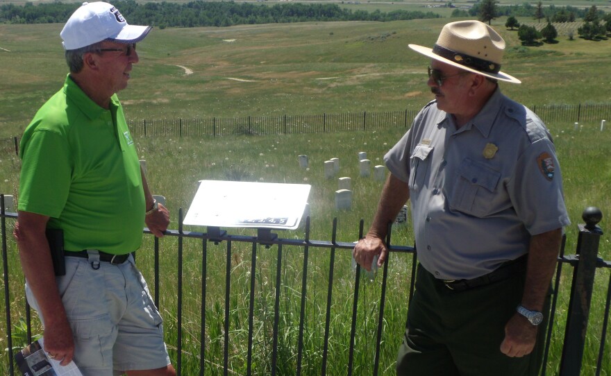 Seasonal Ranger Mike Donahue (right) discuses the Battle of Little Bighorn with Jon Jones atop Custer Hill.