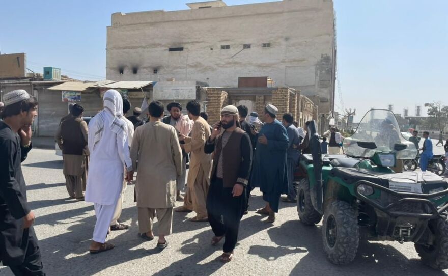 People gather at the scene after a bomb blast hits a Shiite mosque in Afghanistan's southern Kandahar province on Friday.