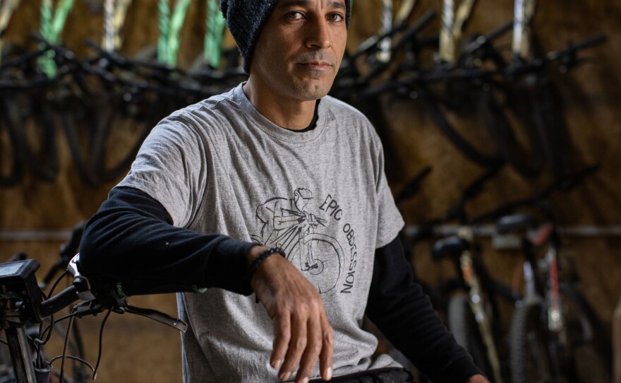 Raanan Momika, who runs a cycling tourism business, sits for a portrait in his shop at Lehavot Habashan, a kibbutz in northern Israel near the border with Lebanon, on Nov. 28.