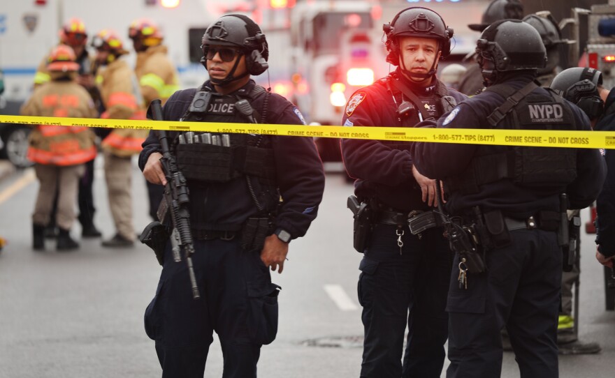 Police and emergency responders gather at the site of a reported shooting of multiple people outside of Brooklyn's 36 Street subway station on Tuesday.