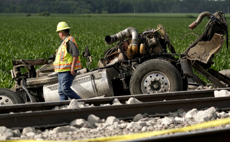 A worker looks over the dump truck that collided with the Amtrak train.