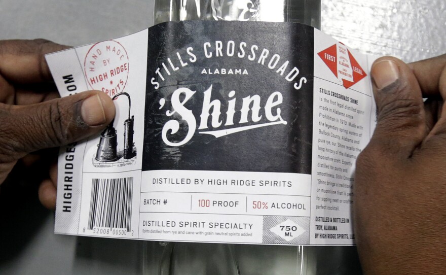 Cynthia Thomas puts labels on bottles of moonshine near Union Springs, Ala., Friday, Oct. 25, 2013. Last year, High Ridge Spirits — Alabama's first legal distillery since Prohibition — joined the growing trend of more than 600 craft distilleries operating around the country.