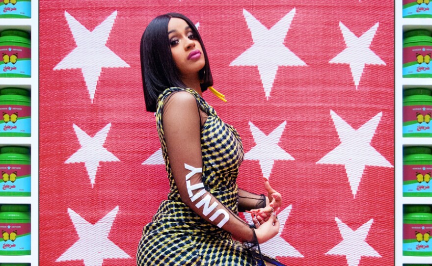 Hassan Hajjaj, born in Morocco in 1961, is often called the Andy Warhol of Marrakesh for his fusion of glamour and everyday life. Both are evident in his 2017 portrait Cardi B Unity. The rap star, dressed in a high-fashion outfit, sits on utilitarian green plastic cartons against a textured fabric backdrop. The frame consists of tins of green tea, each decorated with a butterfly.