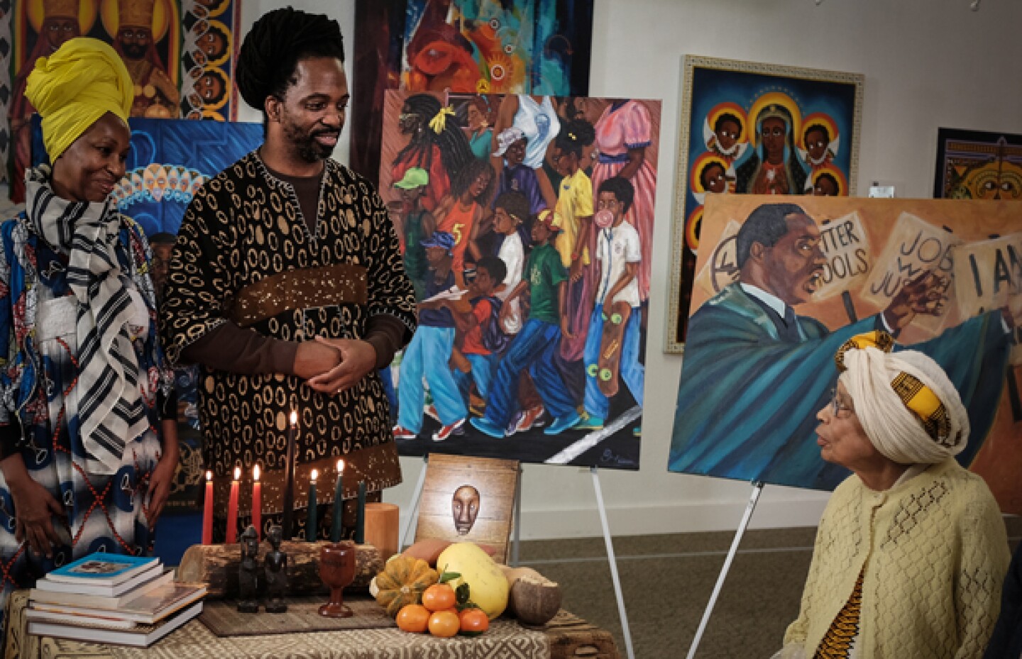 Seneferu and his wife, Karen, address an elder during the Kwanzaa ceremony.