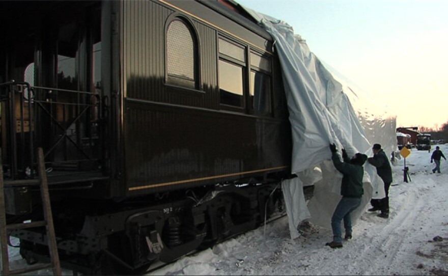 The protective wrapping is removed from the restored Badger #2, perhaps the most valuable rail car in the world.