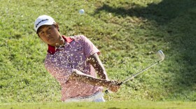Gunn Yang blast out of the greenside bunker on the 15th hole at the U.S. Amateur Championship golf tournament at the Atlanta Athletic Club in Johns Creek, Ga., Aug. 16, 2014. 