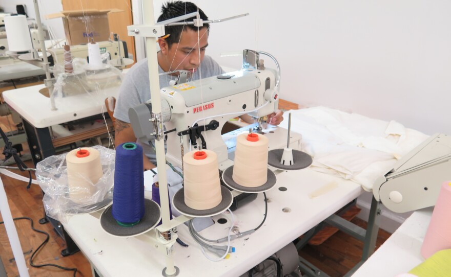 Worker-owner Alfonso Gonzalez pieces together Zady's T-shirts at the Opportunity Threads cooperative in Morganton, N.C.