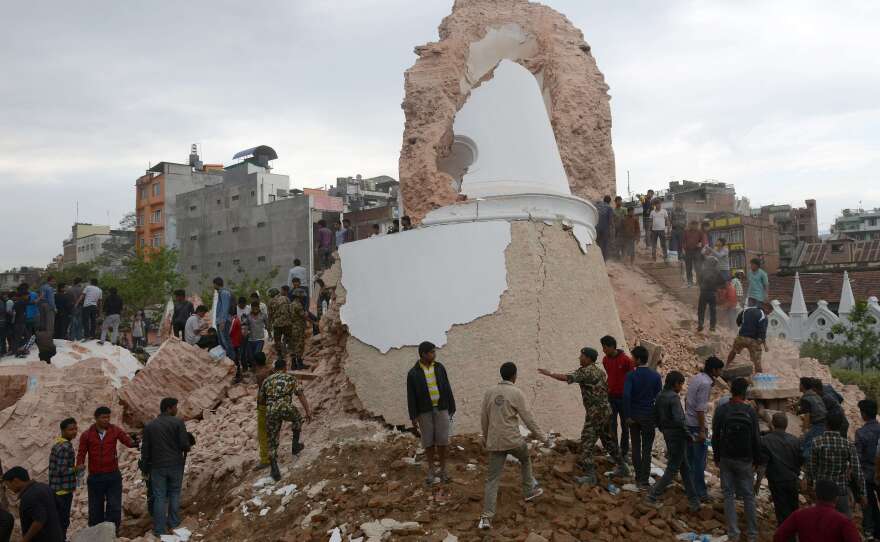 Nepalese rescue members and onlookers gather at the collapsed Dharahara Tower in Kathmandu.