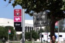 A student walking by a ridesharing drop-off/pick-up location on the San Diego State University campus, Aug. 28, 2023.