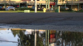A pool of water fills a low corner on West Point Loma Boulevard in San Diego on April 10, 2015. The water came from sprinklers a few blocks away.