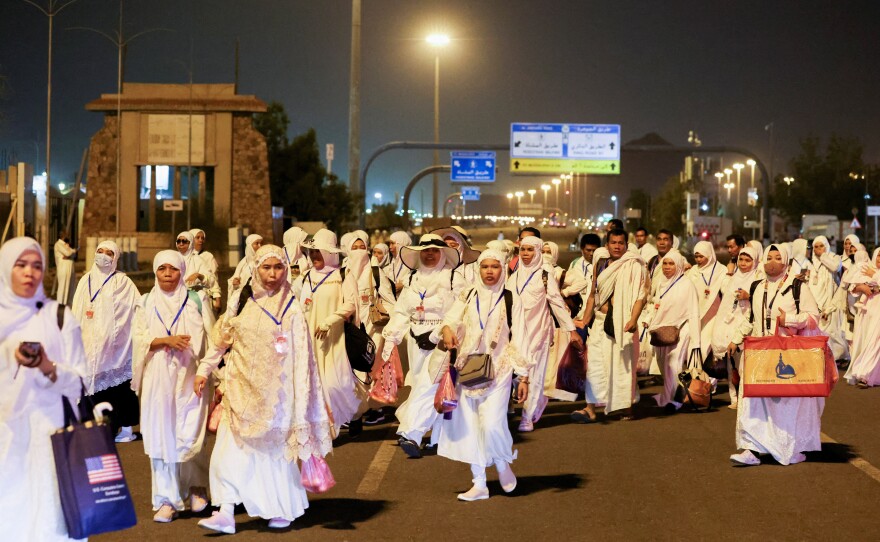 Muslim pilgrims walk to climb the Mount of Mercy at the plain of Arafat during the annual Hajj pilgrimage, outside the holy city of Mecca, Saudi Arabia, Monday.