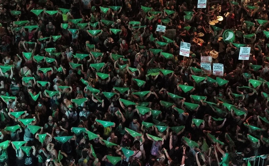Demonstrators display green headscarves outside the Argentine Congress in 2020. The color green has become a symbol of abortion rights around the world.