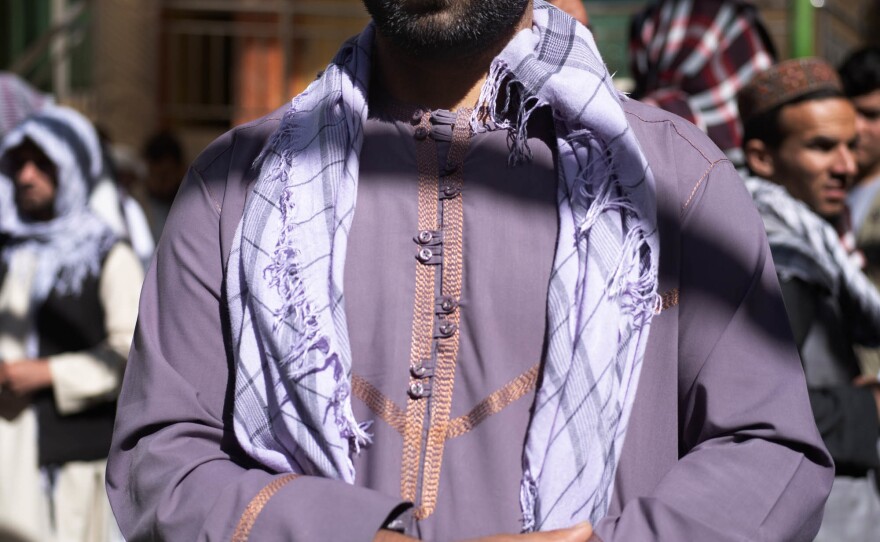 Construction worker Shahzaman Mohammadi, 32, stands in line for food assistance.