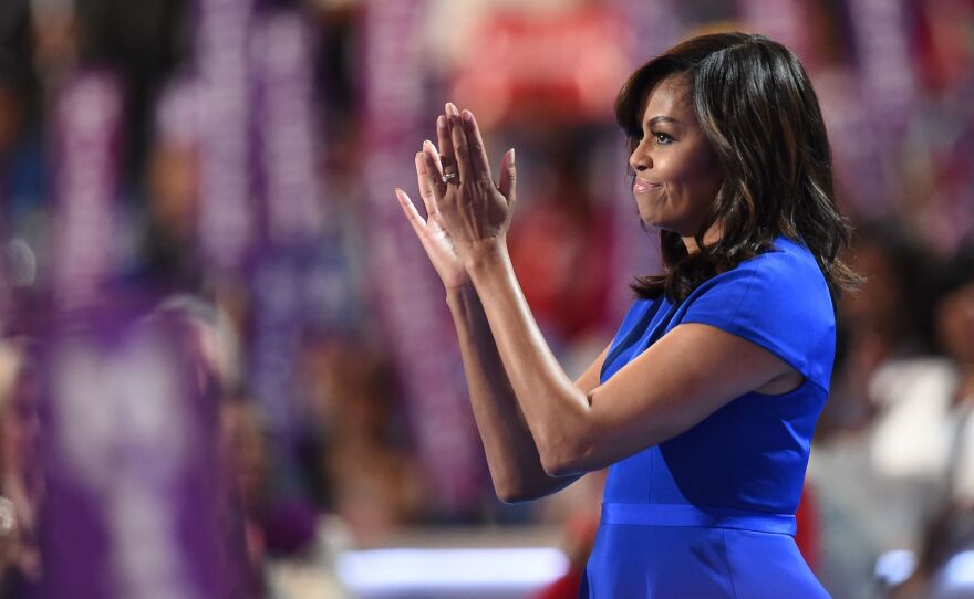 First Lady Michelle Obama applauds from the stage after addressing delegates on the first day of the Democratic National Convention in Philadelphia.