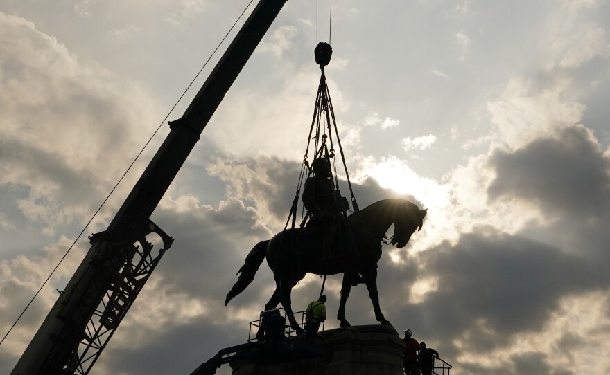 Crews work to remove one of the country's largest remaining monuments to the Confederacy, a towering statue of Confederate Gen. Robert E. Lee on Wednesday in Richmond, Va.