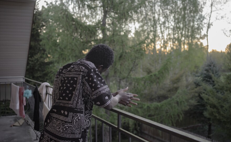 Manuel watches the sunset outside of the home.