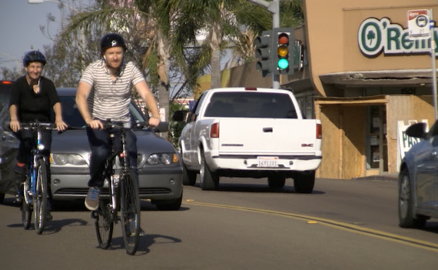 Bike Advisory Committee member Kathy Keehan and KPBS reporter Andrew Bowen bike along Garnet Avenue in Pacific Beach, April 21, 2017.