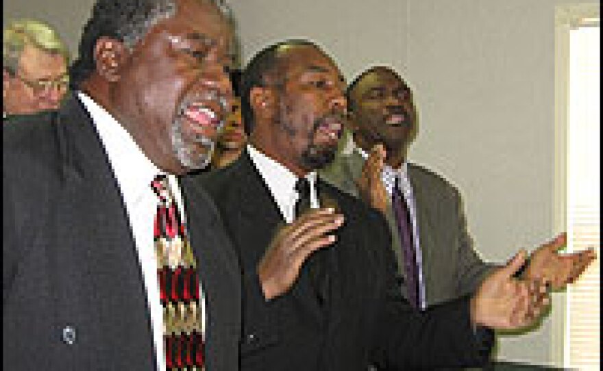Church members worshipped last weekend in a trailer that is Galilee's temporary home. From left: Deacon Cleotis Speight, Minister Jorge Anglin and Deacon Bob Russell.