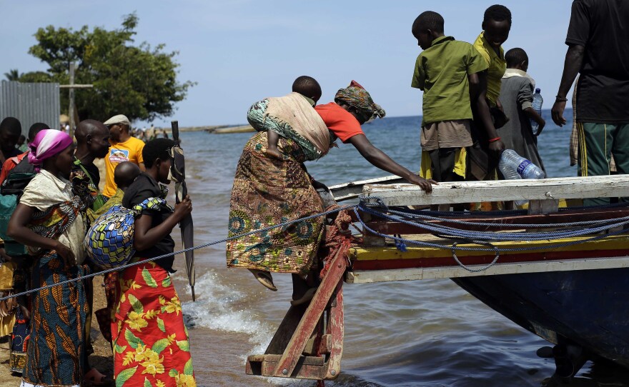 Refugees who fled Burundi's violence and political tension board a speedboat to reach a ship on Lake Tanganyika, Tanzania, on May 23. Some 100,000 refugees have fled Burundi for neighboring countries in recent months.