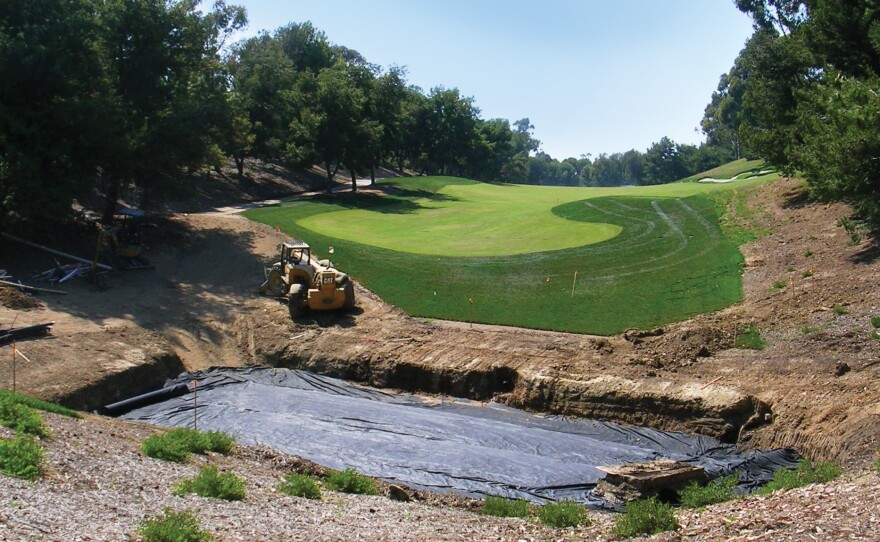 A bio-filtration basin, pictured during installation in 2007, captures water runoff from the Pelican Hill golf club's maintenance facility. The water is filtered through grass, gravel, sand, soil and filter fabric into an underground drainage system.