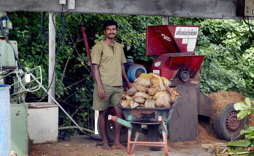 A hotel employee prepares coconut husks for recycling into rope at the luxury Soneva Fushi island resort in the Maldives. It's just one of many initiatives the resort is taking to reduce food waste.