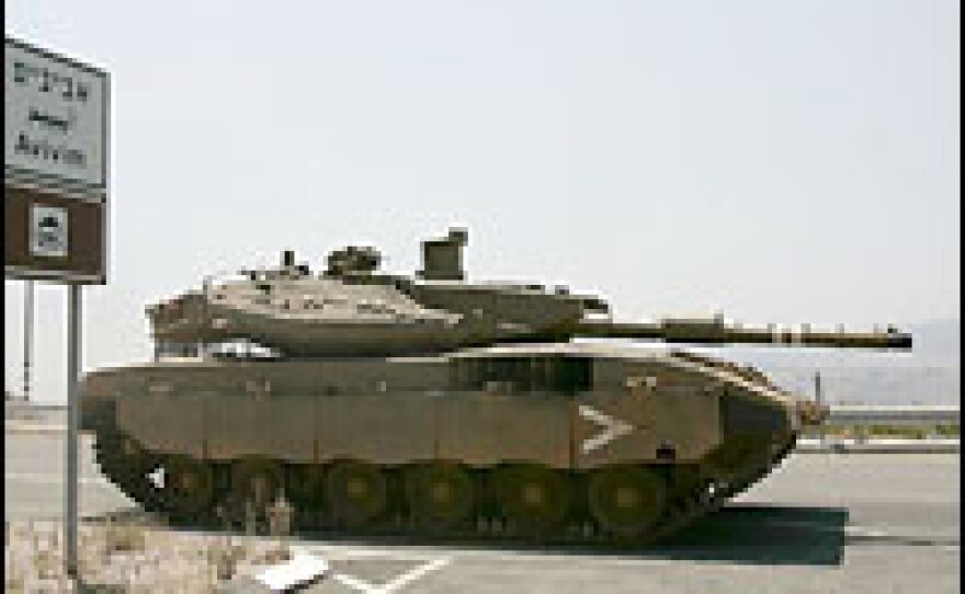 An Israeli tank guards the entrance to the border village of Avivim, Israel.