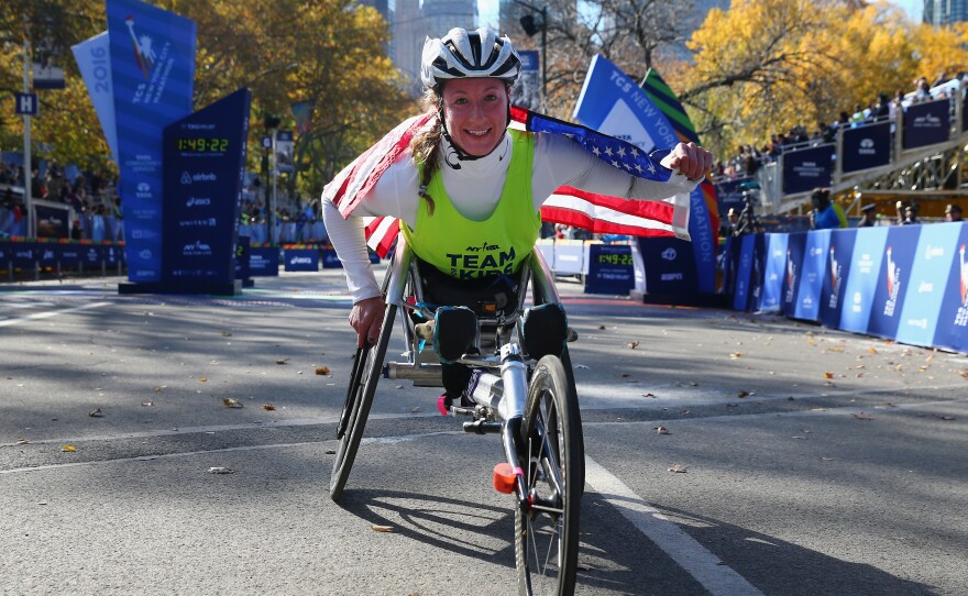 Tatyana McFadden of the United States celebrates winning the Professional Women's Wheelchair Division for the fourth consecutive time during the 2016 New York City Marathon.