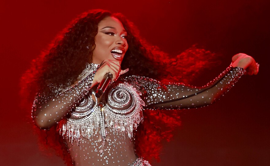Megan Thee Stallion performs onstage during the 2023 LA Pride in the Park Festival. In the first episode of its second season, the <em>Louder Than A Riot</em> podcast examines the backlash Megan faced after being shot by rapper Tory Lanez.