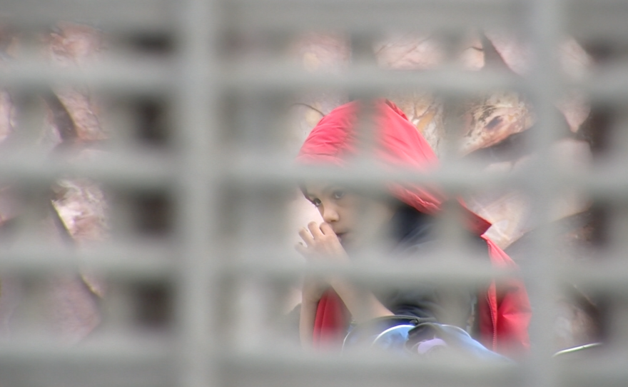 A young boy can be seen in Tijuana through the U.S.-Mexico border fence, Dec. 19, 2015.