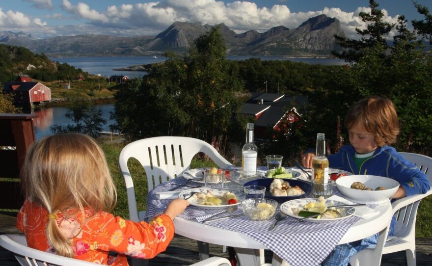 Marcus, 6, and Nora, 4, eat dinner on their first night at home on Rødøy.