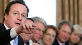 Britain's new prime minister, David Cameron, makes a point at the first Cabinet meeting of his new coalition government. The new ministers began by giving themselves a pay cut.