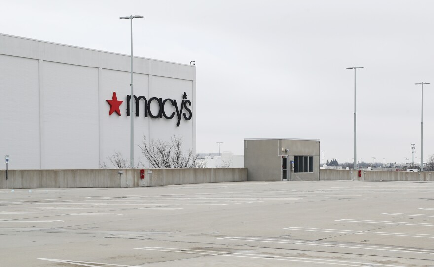 An empty parking lot surrounds the Macy's at the Roosevelt Field Mall on March 20 in East Garden City, N.Y. The retail chain had previously announced plans to close about 125 stores over the next three years.
