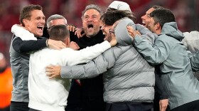 PSG's head coach Luis Enrique, center, celebrates with the other members of the team after the Champions League semifinal second leg soccer match between Bayern Munich and Paris Saint Germain in Munich, Germany, Wednesday, May 6, 2026.