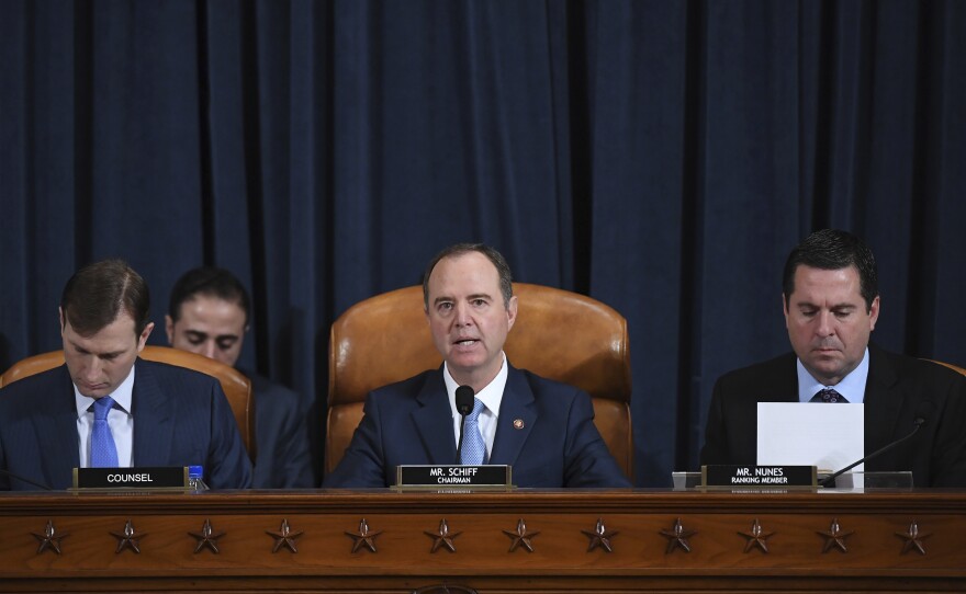 House Intelligence Committee Chairman Adam Schiff, D-Calif. (center); ranking member Rep. Devin Nunes of California (right); and committee counsel Daniel Goldman hold an impeachment inquiry hearing on Nov. 21. Schiff has released the panel's report on the inquiry.