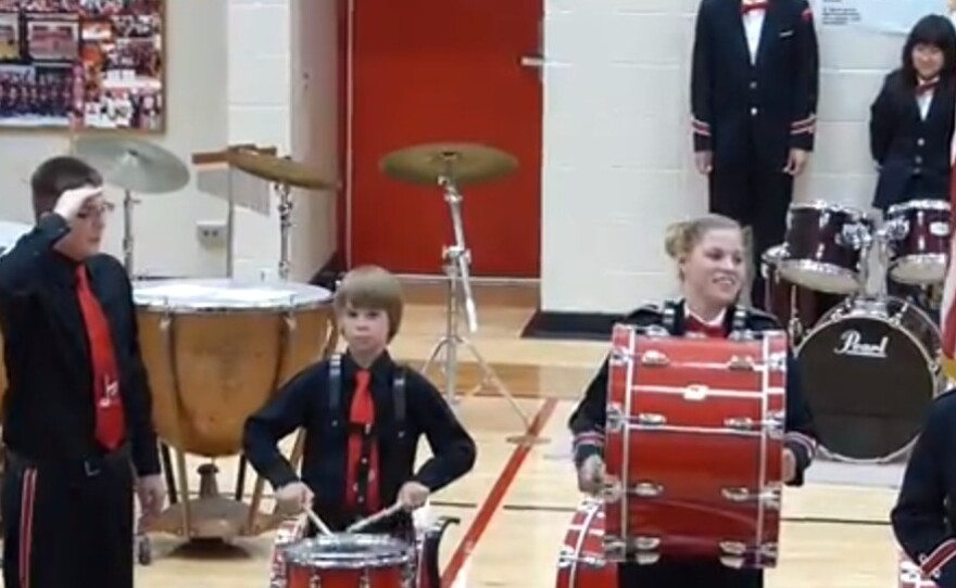 Andrew Pawelczyk, far left, saluting the flag after his cymbal crashed to the floor.