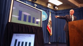 California Governor Jerry Brown points to a chart as he speaks to reporters as he announces his proposed budget at the California State Capitol on January 10, 2011 in Sacramento, California.