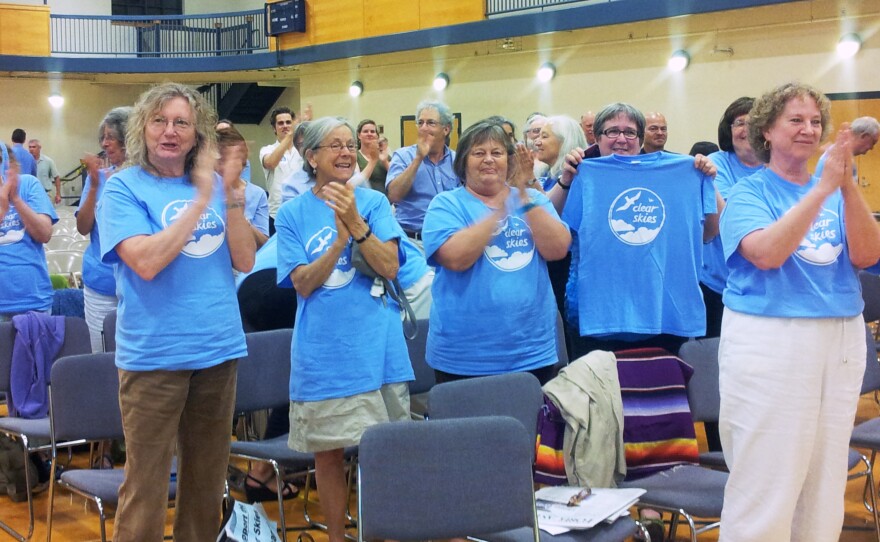 South Portland residents applaud passage of the Clear Skies Ordinance on Monday.