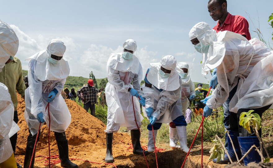 Red Cross workers bury an Ebola victim at the Rwampara Cemetery, in Rwampara, Congo, May 23, 2026.