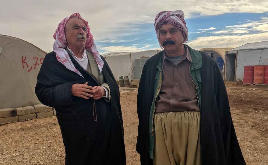 Saeed Ahmed Khalaf, left, and his family live in a tent on Mount Sinjar. He believes the U.S. would either help protect the Yazidis in Sinjar or help the group emigrate to a safe place.
