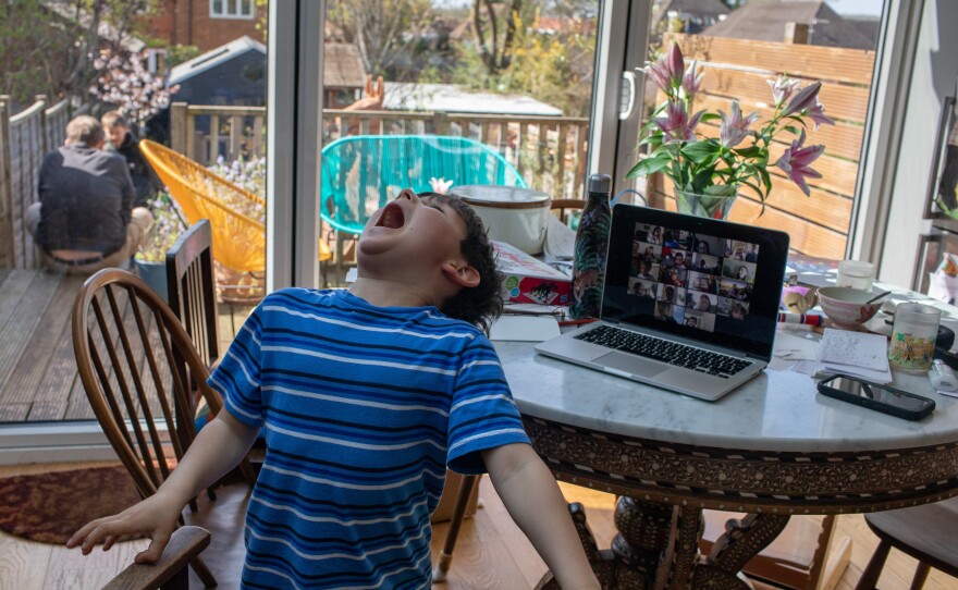 Joe takes part in a video meeting with his classmates. He misses his friends and has only been able to catch up with them online.