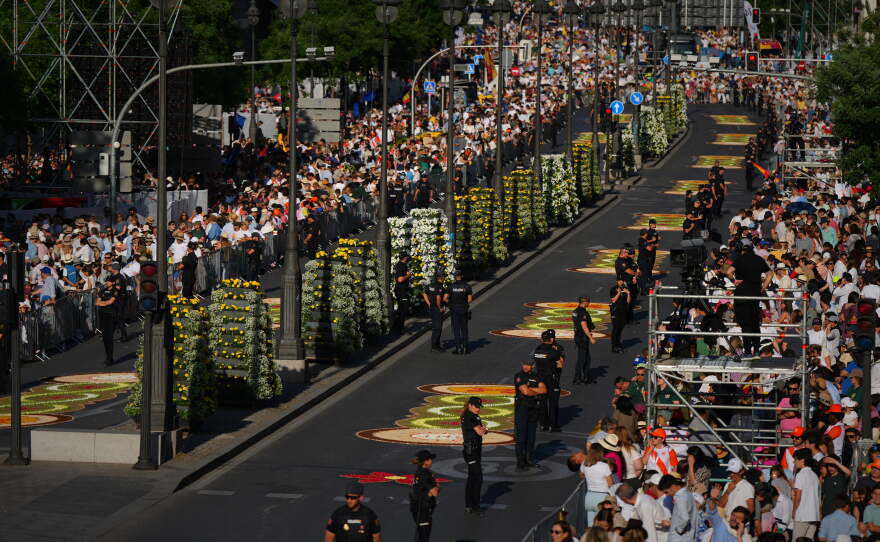 People wait for the arrival of Pope Leo XIV ahead of a Holy Mass and Corpus Christi procession at Plaza de Cibeles in Madrid, Spain, Sunday, June 7, 2026, on the second day of his seven-day apostolic visit to mainland Spain and the Canary Islands.
