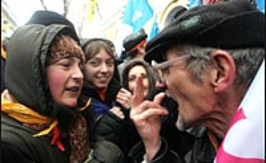 A supporter of opposition leader Viktor Yushchenko, decorated with orange campaign ribbons, argues with a supporter of Prime Minister Viktor Yanukovich, during a rally outside Ukraine's top court in Kiev, Nov. 29.