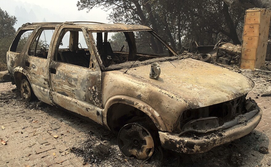 A car destroyed by the Soberanes fire in Big Sur, Calif. Lodge managers and cafe owners there are facing cancelled bookings after fire officials warned that crews will likely be battling the fire for another month.
