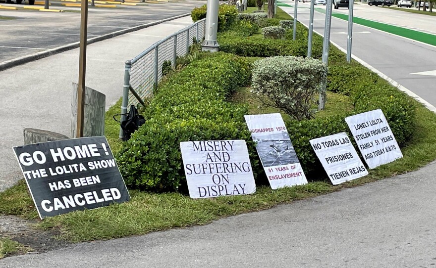 Protesters display messages outside the entrance to discourage visitors to the Seaquarium